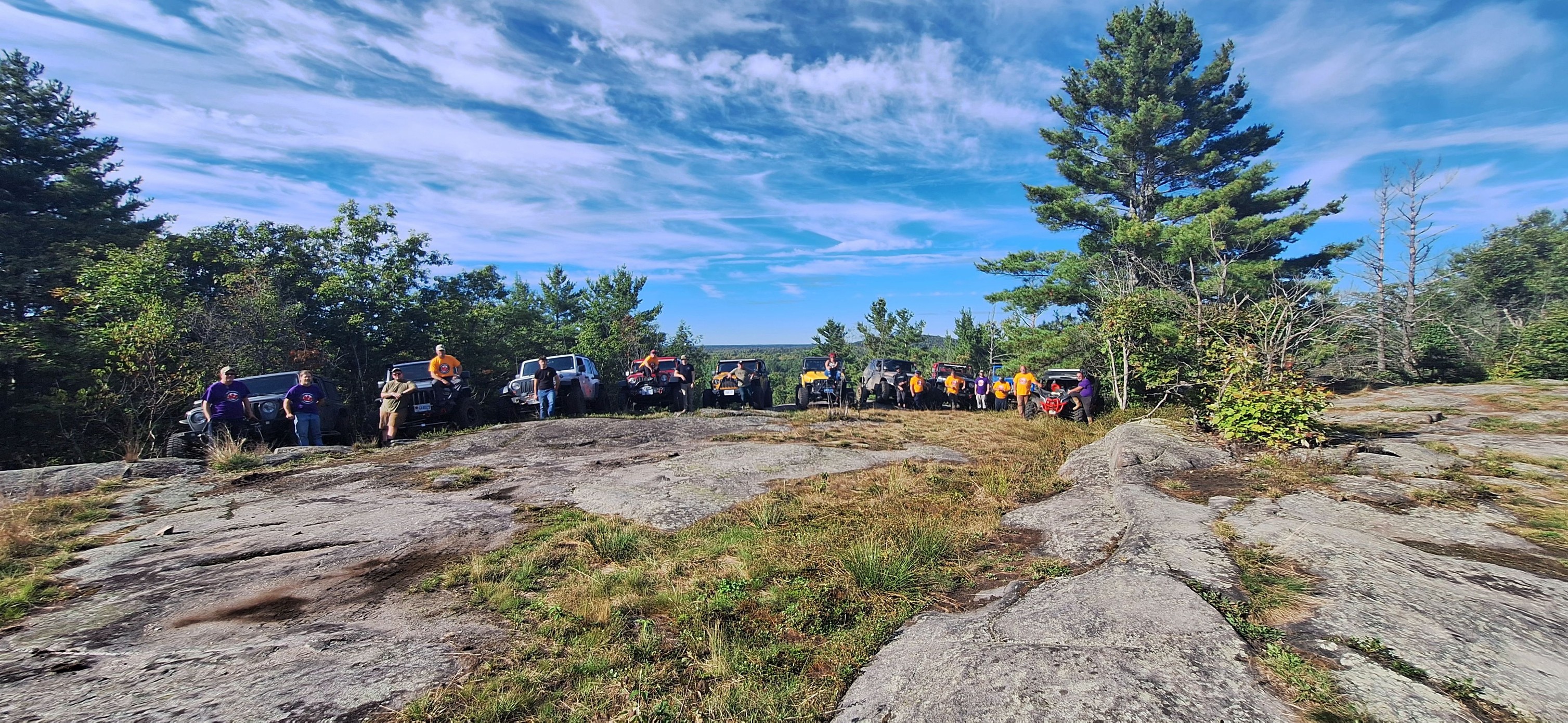 JeepsInRowOverRock